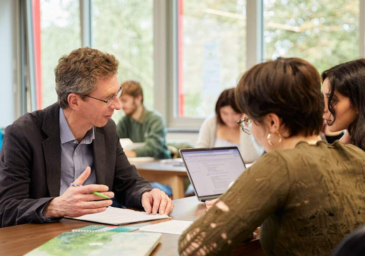 A tutor and students take part in a seminar